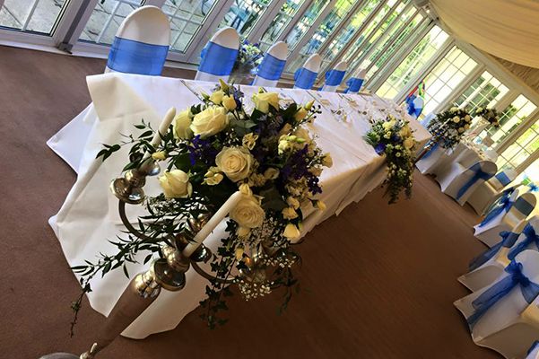 chairs with blue sash and yellow flowers